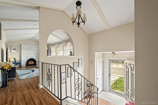 6854 S Willow St, Centennial, CO 80112 - entrance foyer with an inviting chandelier, plenty of natural light, lofted ceiling with beams, and wood finished floors