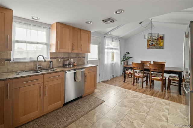6854 S Willow St, Centennial, CO 80112 - kitchen with visible vents, decorative backsplash, a sink, appliances with stainless steel finishes, and vaulted ceiling