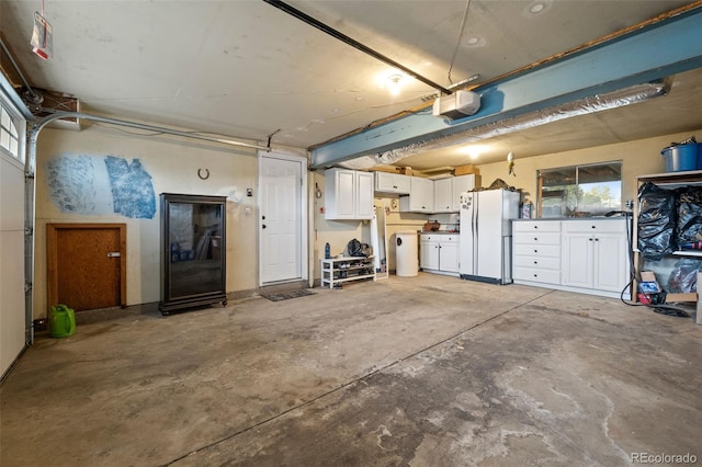 6854 S Willow St, Centennial, CO 80112 - garage featuring freestanding refrigerator and a garage door opener