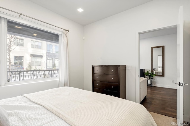bedroom featuring baseboards and dark wood-style floors