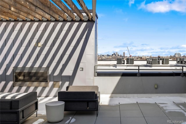 view of patio featuring a view of city and a balcony