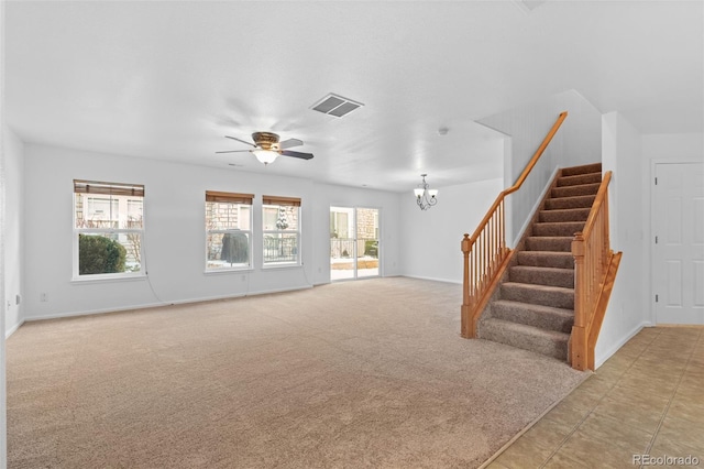 unfurnished living room featuring ceiling fan with notable chandelier and light carpet