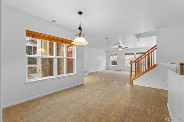 unfurnished living room with ceiling fan