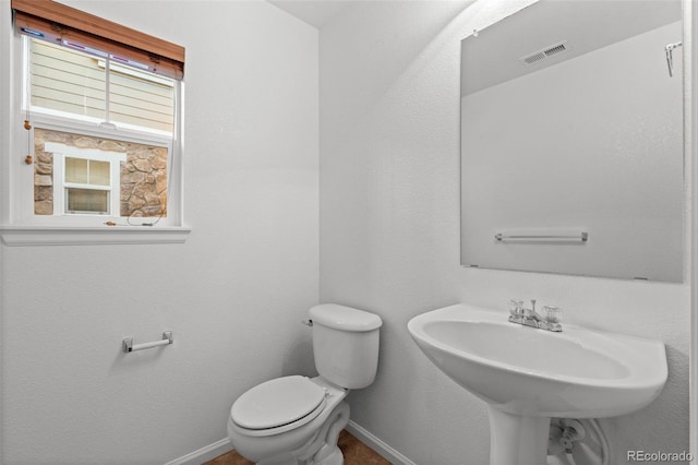 bathroom featuring toilet and sink