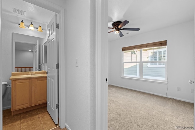 bathroom with ceiling fan, vanity, and toilet