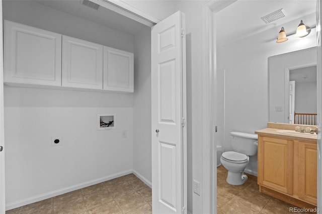 bathroom featuring toilet, tile patterned flooring, and vanity