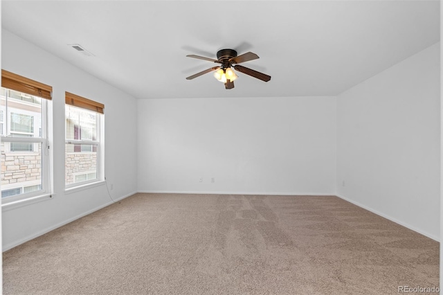 carpeted spare room with ceiling fan