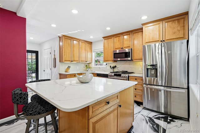 751 Poplar St, Denver, CO 80220 - kitchen with appliances with stainless steel finishes, recessed lighting, backsplash, a kitchen island, and light stone counters
