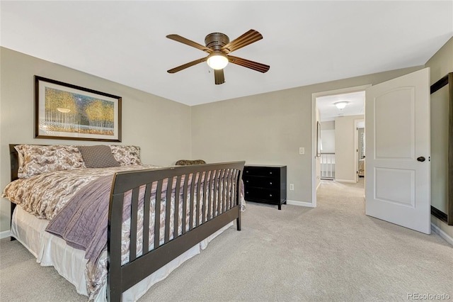 bedroom with ceiling fan and light carpet