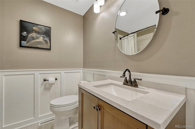 bathroom with vanity, a shower with curtain, and toilet