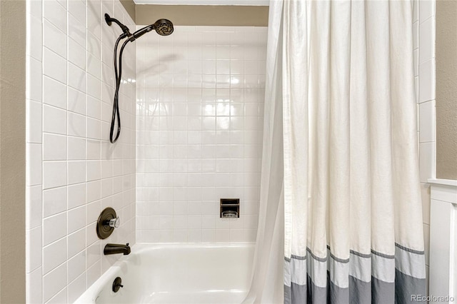 bathroom with shower / bath combo with shower curtain