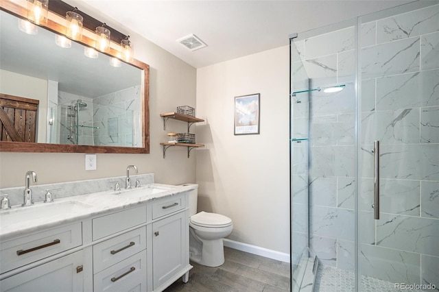 bathroom with walk in shower, vanity, and toilet