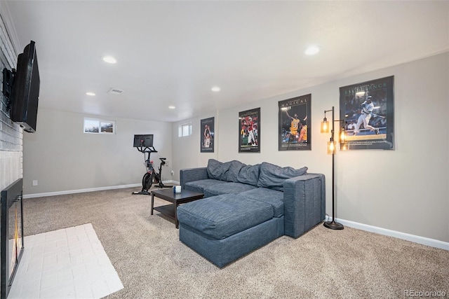 living room with a fireplace and carpet