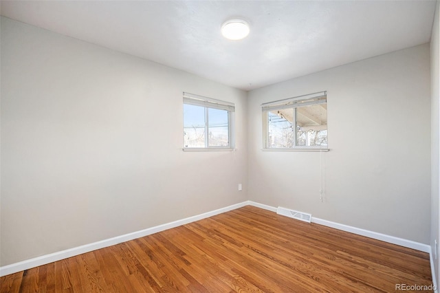 empty room with hardwood / wood-style floors