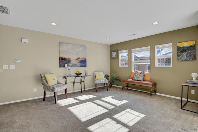 sitting room featuring light colored carpet