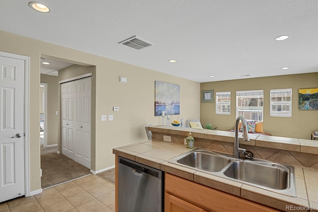 kitchen with tile counters, dishwasher, sink, a textured ceiling, and light tile patterned flooring