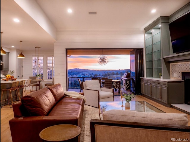 living area featuring recessed lighting, visible vents, and light wood finished floors