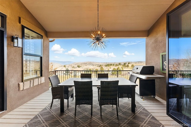 exterior space with a mountain view and outdoor dining area