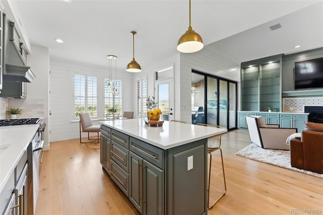 kitchen featuring light wood-style floors, open floor plan, and light countertops