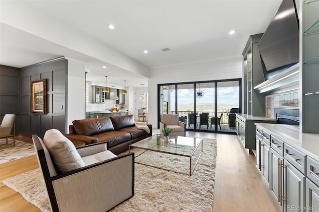 living room with recessed lighting and light wood-style flooring