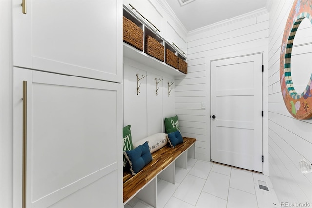 mudroom featuring light tile patterned flooring and crown molding