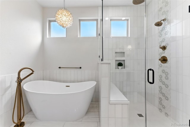 bathroom featuring a wainscoted wall, a soaking tub, tile walls, and a shower stall