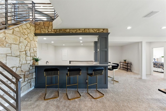 bar with visible vents, recessed lighting, stairway, wet bar, and light colored carpet