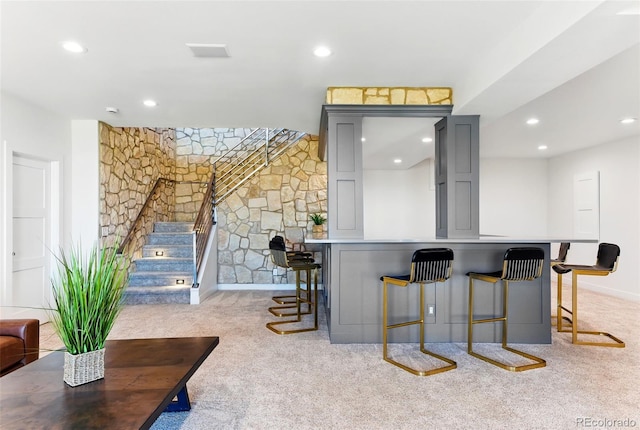 bar with light carpet, recessed lighting, and stairs