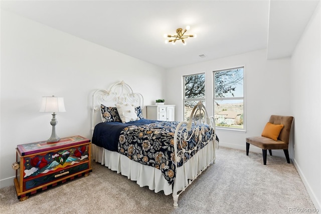 bedroom featuring baseboards and light carpet