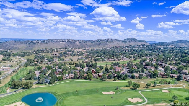 drone / aerial view with a mountain view and golf course view