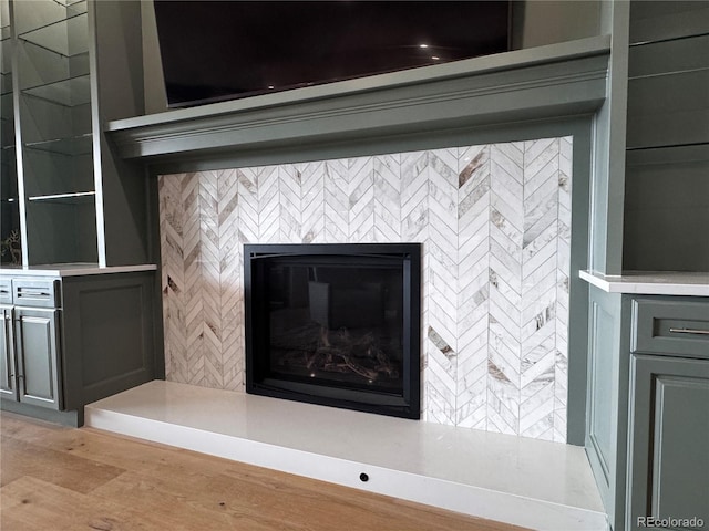 interior details featuring a tile fireplace