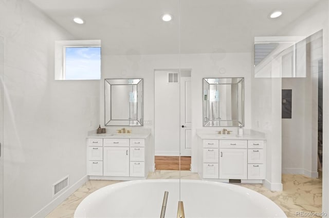 bathroom featuring vanity and a bath