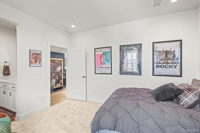 carpeted bedroom featuring ensuite bathroom