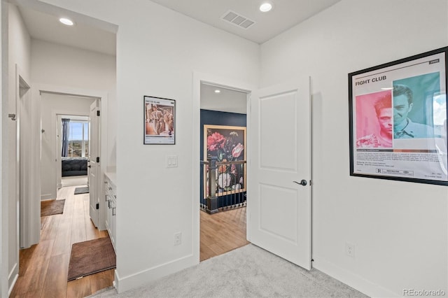 hallway with light hardwood / wood-style floors