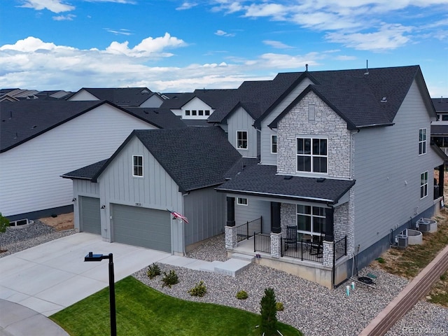 view of front of home with a garage and central air condition unit