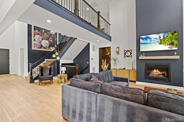 living room featuring hardwood / wood-style flooring and a high ceiling