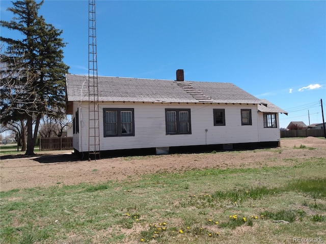 view of side of property with a yard