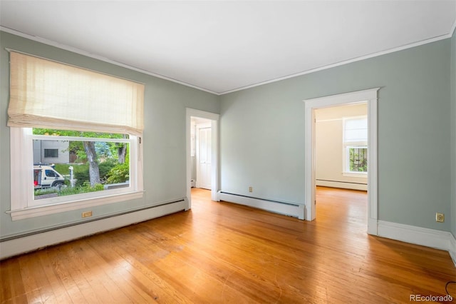 130 S Humboldt St, Denver, CO 80209 - spare room featuring baseboard heating, ornamental molding, and healthy amount of natural light