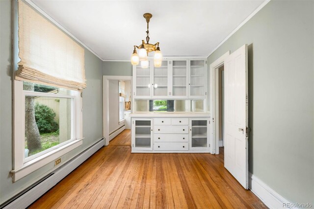 130 S Humboldt St, Denver, CO 80209 - unfurnished dining area with baseboard heating, ornamental molding, a chandelier, light wood finished floors, and a baseboard radiator
