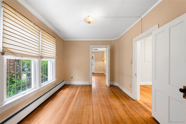 130 S Humboldt St, Denver, CO 80209 - empty room featuring a baseboard heating unit, light wood-type flooring, baseboards, and crown molding