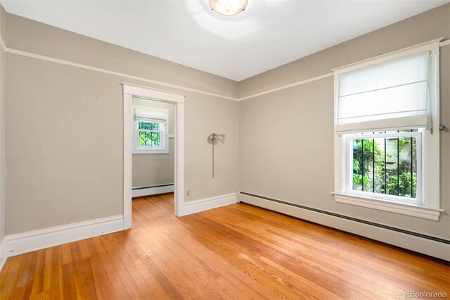 130 S Humboldt St, Denver, CO 80209 - spare room with baseboard heating, light wood-style floors, and baseboards