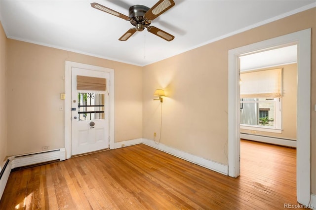 130 S Humboldt St, Denver, CO 80209 - unfurnished room featuring a baseboard radiator, healthy amount of natural light, wood-type flooring, ceiling fan, and crown molding
