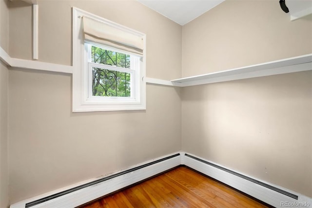130 S Humboldt St, Denver, CO 80209 - spare room featuring a baseboard heating unit and wood finished floors