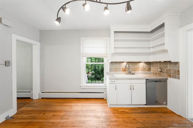 130 S Humboldt St, Denver, CO 80209 - bar area with stainless steel dishwasher, a sink, decorative backsplash, and light wood-style floors