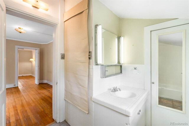 130 S Humboldt St, Denver, CO 80209 - bathroom featuring vanity, hardwood / wood-style flooring, baseboards, and ornamental molding