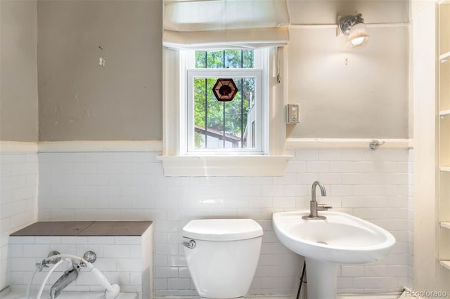 130 S Humboldt St, Denver, CO 80209 - bathroom with toilet, wainscoting, tile walls, and a sink