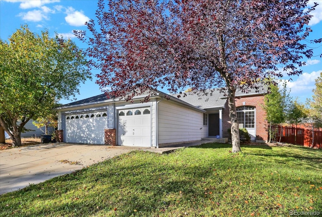 single story home with a front lawn and a garage