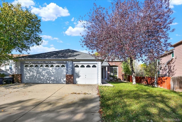 view of front of home featuring a front yard and a garage