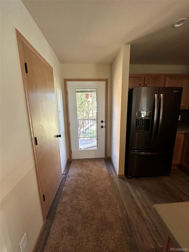 entryway with baseboards and wood finished floors