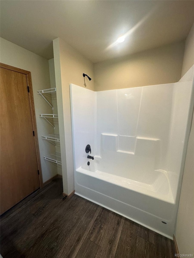full bathroom with bathing tub / shower combination and wood finished floors